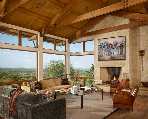 A western art print of Texas Longhorns cattle along the Chisholm trail from the Stockyards, against a dusty trail background. An oil painting by wildlife artist James Corwin. Hanging in living room wall art home decor.