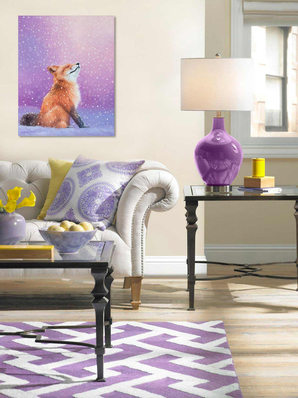 An oil painting of a red fox peacefully watching the snow fall with a pink purple background by wildlife artist James Corwin. Hanging in living room wall art home decor.