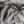 A limited edition giclee canvas print featuring two highland cows in a natural landscape with a predominantly gray and white color palette. Detail of Cow Hair.