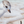 Baby plover chick finds a sand dollar on a beach uncovered by waves and sea foam from the ocean. An oil painting by wildlife artist James Corwin. Detail of the piping plover sandpiper.