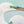 An oil painting of two great white egrets with a seafoam green background. Limited Edition Giclee Canvas Print by wildlife artist James Corwin.