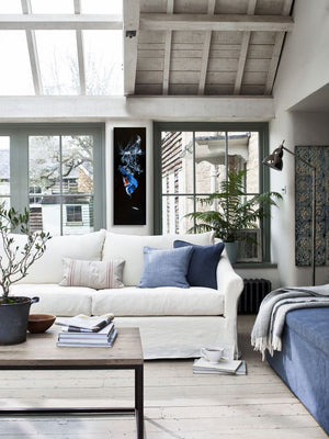 A belted kingfisher dives through water to catch a minnow fish. A giclee canvas print of an oil painting by wildlife artist James Corwin. Hanging in home wall decor.