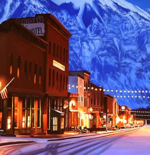A canvas print depicting a snowy Main Street in Telluride, Colorado, with illuminated lights and snow-covered mountains in the background. Cityscape art by wildlife artist James Corwin.