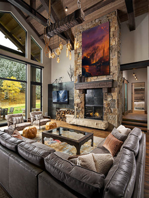 An oil painting as a limited edition canvas print depicting a bull moose in a fiery wildfire setting by Montana wildlife artist James Corwin. Hanging in living room wall art home decor.