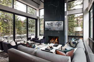 A limited edition giclee canvas print featuring a group of wolves in a snowy mountain landscape. The print is gallery-wrapped by wildlife artist James Corwin. Hang ing in Living Room wall art home decor.