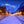 A canvas print depicting a snowy Main Street in Telluride, Colorado, with illuminated lights and snow-covered mountains in the background. Cityscape art by wildlife artist James Corwin.