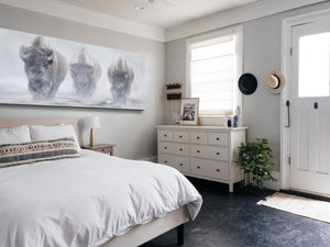 A giclee canvas print of three yellowstone bison in a misty winter setting from an oil painting by James Corwin wildlife artist. Hanging in bedroom wall decor.