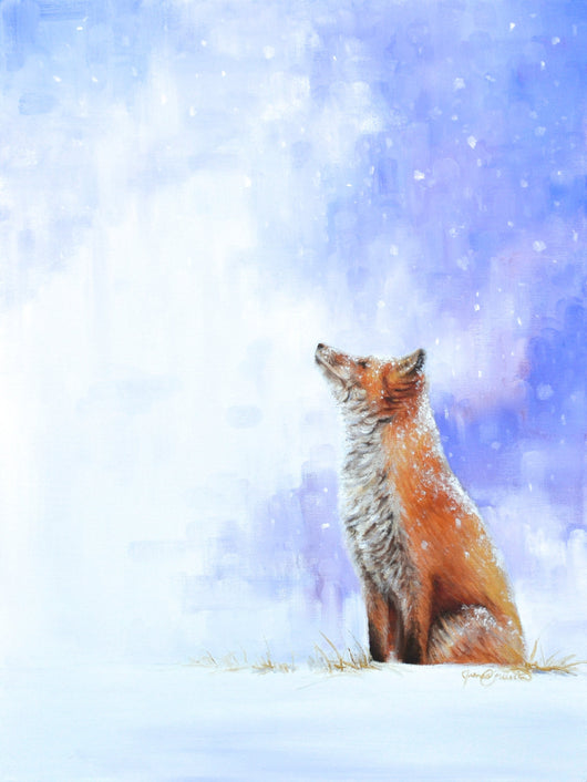 A red fox sits peacefully watching the snow fall.